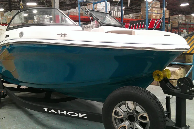 The Image of 2025 Tahoe 185 S boat on trailer in warehouse setting. - 0