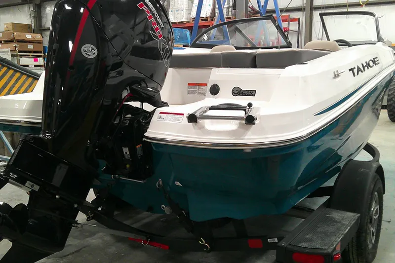 Slide: The Image of 2025 Tahoe 185 S boat with Mercury Pro XS engine in a warehouse setting. - 2