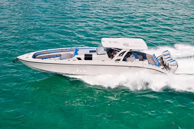 The Image of 2023 Midnight Express 43 Solstice speedboat cruising on clear turquoise waters. - 0