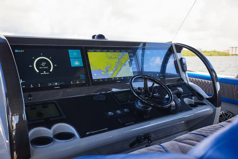 Slide: The Image of Cockpit of 2023 Midnight Express 43 Solstice with advanced navigation displays and steering wheel. - 14