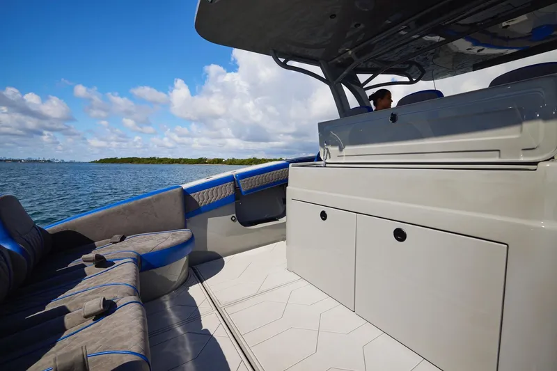 Slide: The Image of 2023 Midnight Express 43 Solstice luxury boat interior with seating and storage, on a sunny day. - 16