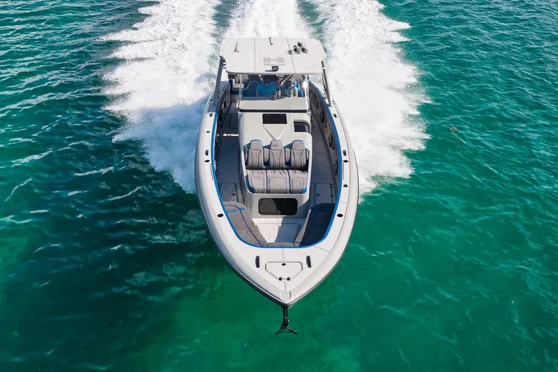 Slide: The Image of 2023 Midnight Express 43 Solstice cruising on clear turquoise waters. - 2