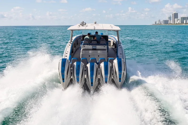 Slide: The Image of 2023 Midnight Express 43 Solstice speedboat cruising on ocean near city skyline. - 4