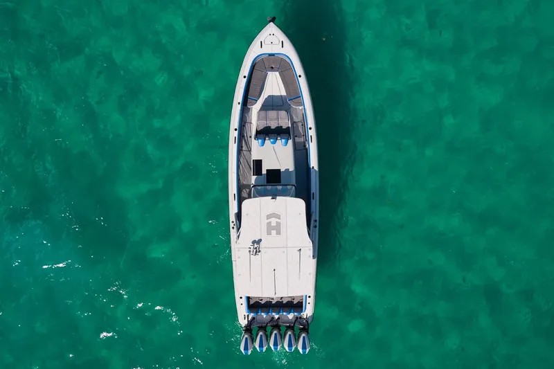 Slide: The Image of Aerial view of 2023 Midnight Express 43 Solstice boat on turquoise water. - 5