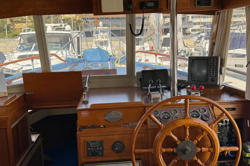 Slide: The Image of 1978 Grand Banks 42 Classic yacht helm with wooden wheel and navigation equipment. - 13