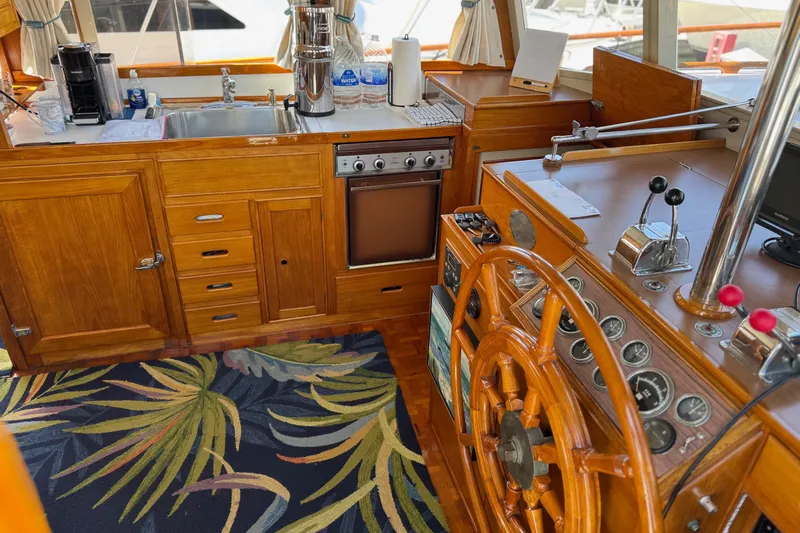 Slide: The Image of Interior of a 1978 Grand Banks 42 Classic yacht with wooden helm and kitchen area. - 15