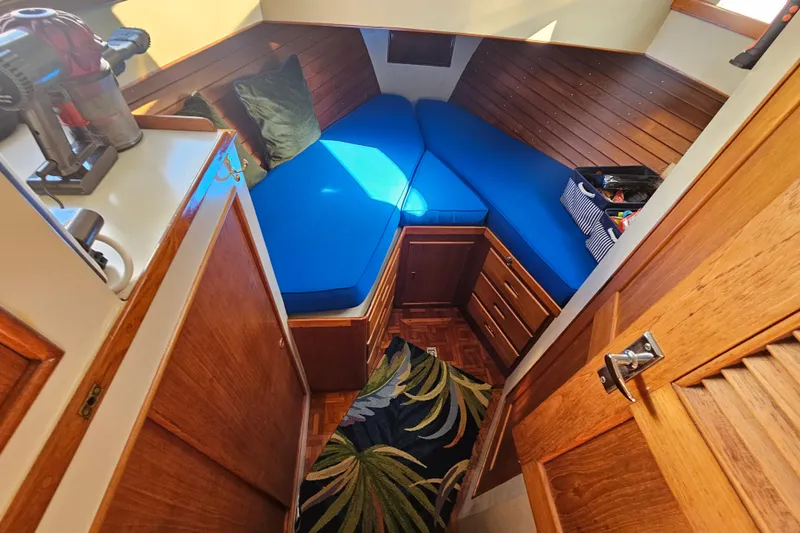 Slide: The Image of Cozy cabin interior of 1978 Grand Banks 42 Classic with blue cushions and wooden accents. - 18