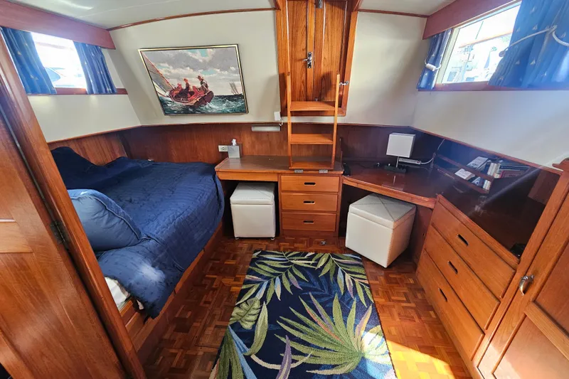 Slide: The Image of Cozy cabin interior of 1978 Grand Banks 42 Classic with bed, desk, and nautical decor. - 19
