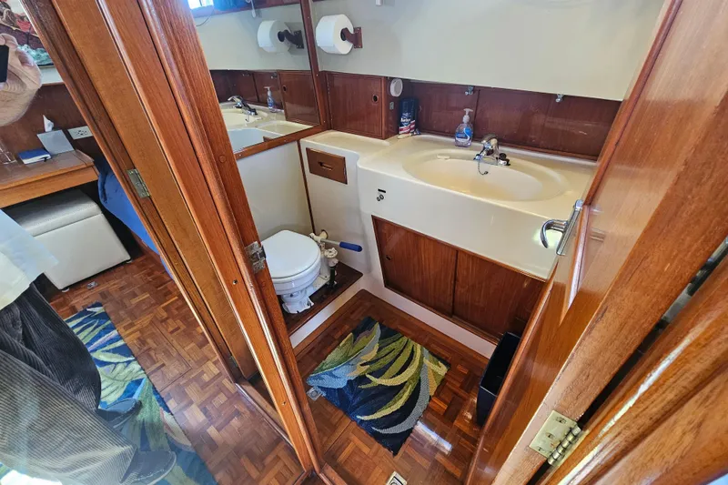 Slide: The Image of Bathroom interior of a 1978 Grand Banks 42 Classic yacht with wooden cabinetry. - 21