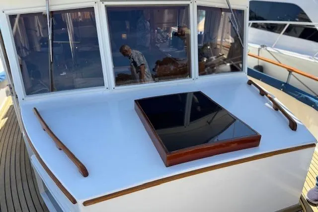 Slide: The Image of 1978 Grand Banks 42 Classic yacht with wooden accents and reflective windows. - 22