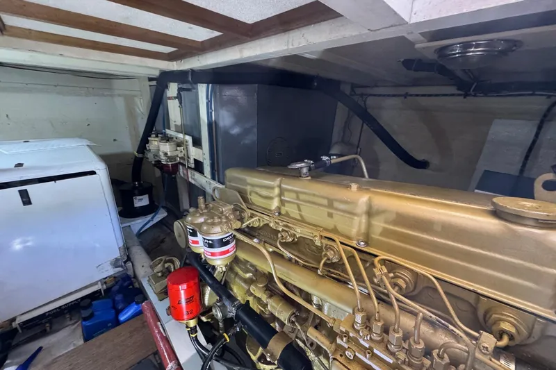 Slide: The Image of Engine room of a 1978 Grand Banks 42 Classic yacht, showcasing detailed machinery. - 24