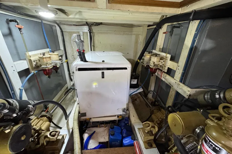Slide: The Image of Engine room of a 1978 Grand Banks 42 Classic yacht, showcasing machinery and components. - 27