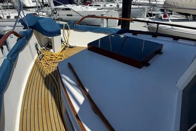 Slide: The Image of 1978 Grand Banks 42 Classic yacht deck with wooden railings and blue covers. - 5