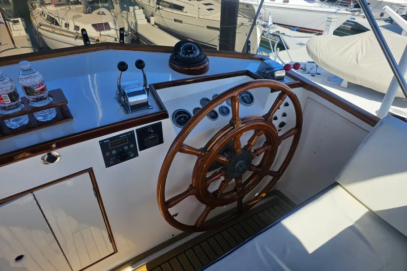 Slide: The Image of Helm of 1978 Grand Banks 42 Classic yacht with wooden wheel and controls. - 7