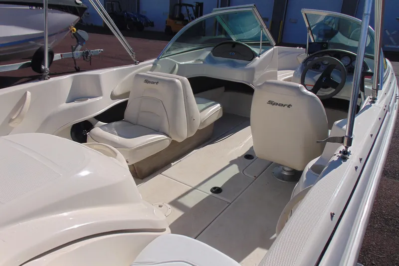 Slide: The Image of 2007 Sea Ray 175 Sport boat interior with white seating and steering wheel. - 7