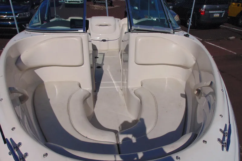 Slide: The Image of 2007 Sea Ray 175 Sport boat interior with white seating and open bow design. - 9