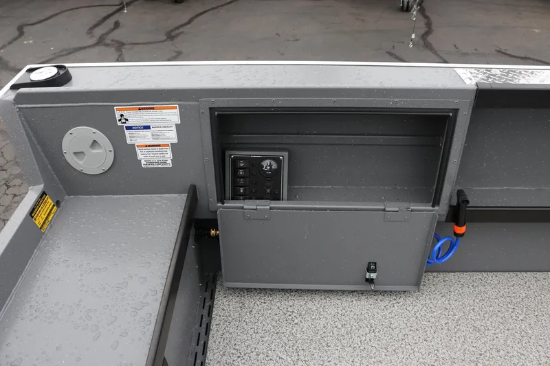 Slide: The Image of 2026 Alumaweld Columbia 23 boat interior with control panel and storage compartment. - 13