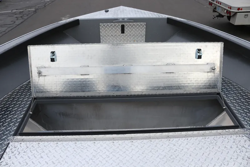 Slide: The Image of Open storage compartment on 2026 Alumaweld Columbia 23 boat with diamond plate flooring. - 17