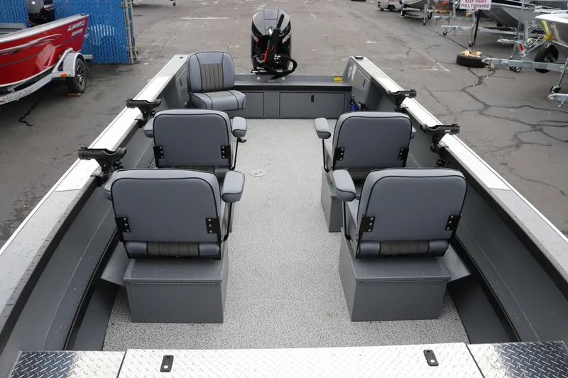 Slide: The Image of 2026 Alumaweld Columbia 23 boat interior with four gray seats and motor. - 19