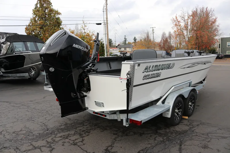 Slide: The Image of 2026 Alumaweld Columbia 23 boat with Mercury engine on trailer, parked outdoors. - 29