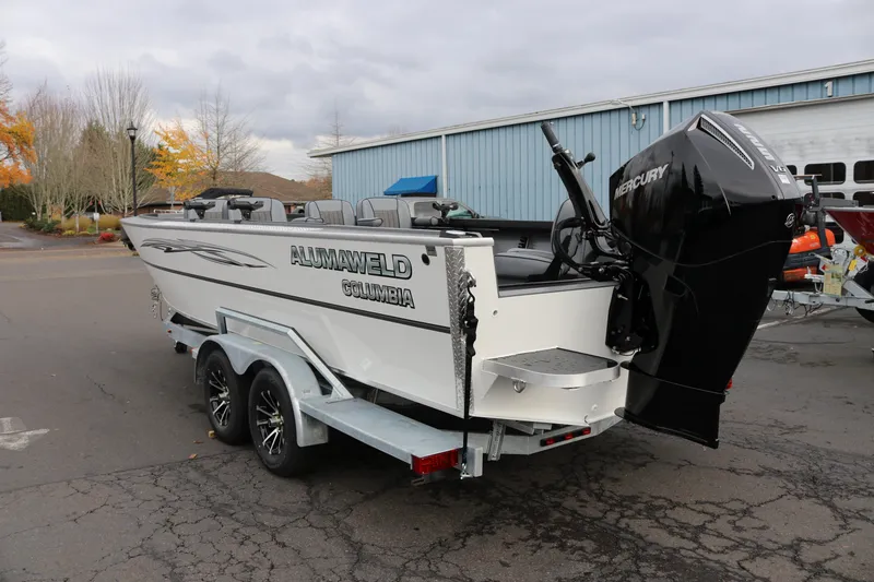 Slide: The Image of 2026 Alumaweld Columbia 23 boat with Mercury engine on trailer, parked outdoors. - 31