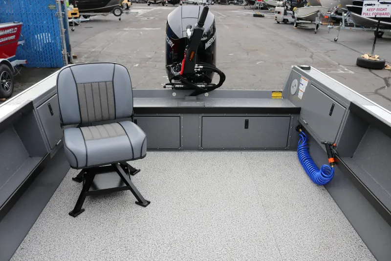 Slide: The Image of 2026 Alumaweld Columbia 23 boat interior with seating and motor, showcasing spacious design. - 5