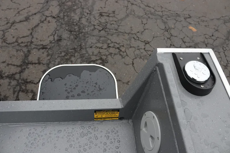 Slide: The Image of 2026 Alumaweld Columbia 23 boat detail with wet surfaces and capacity label. - 8