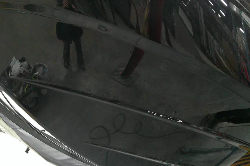 Slide: The Image of 2025 Tahoe T18 boat with sleek black finish in a workshop setting. - 4