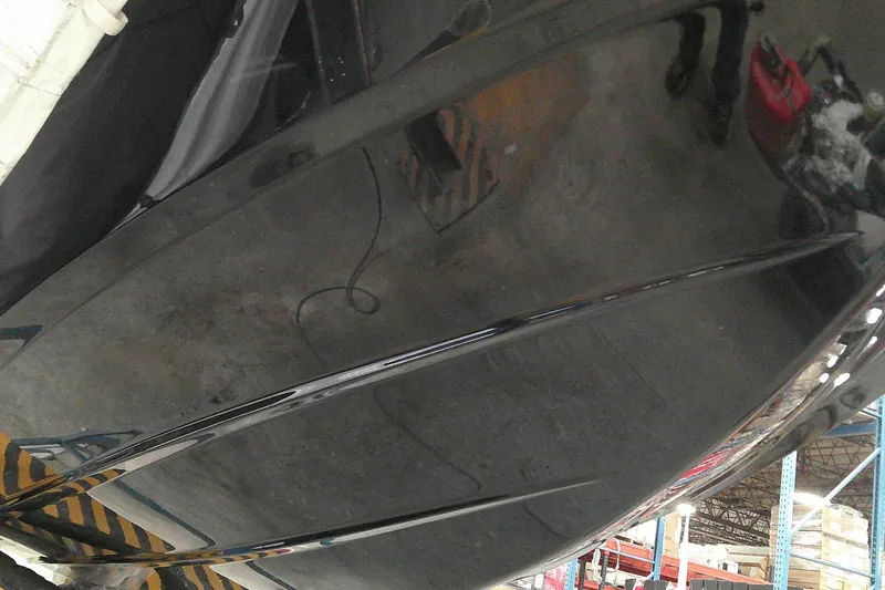 Slide: The Image of 2025 Tahoe T18 boat hull in a warehouse setting, showcasing sleek design and glossy finish. - 5