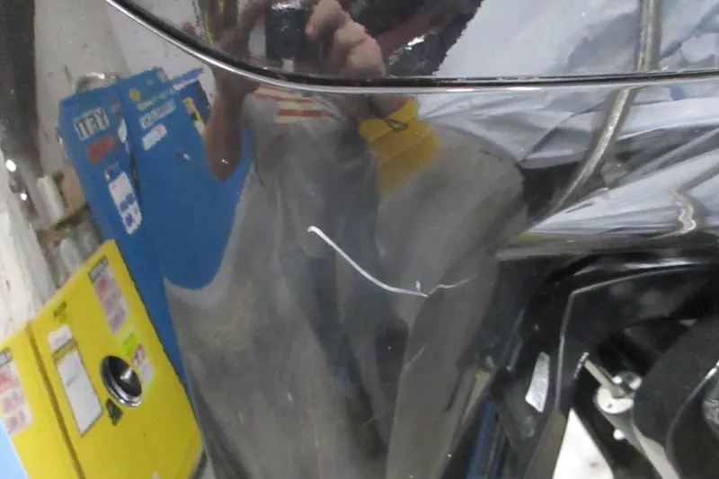 Slide: The Image of Close-up of a 2025 Tahoe T18 with visible scratch on the black surface. - 6