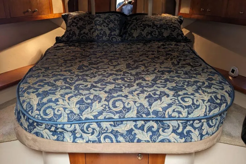 Slide: The Image of Luxurious bed in 2003 Cruisers 3970 yacht cabin with elegant floral bedding. - 10