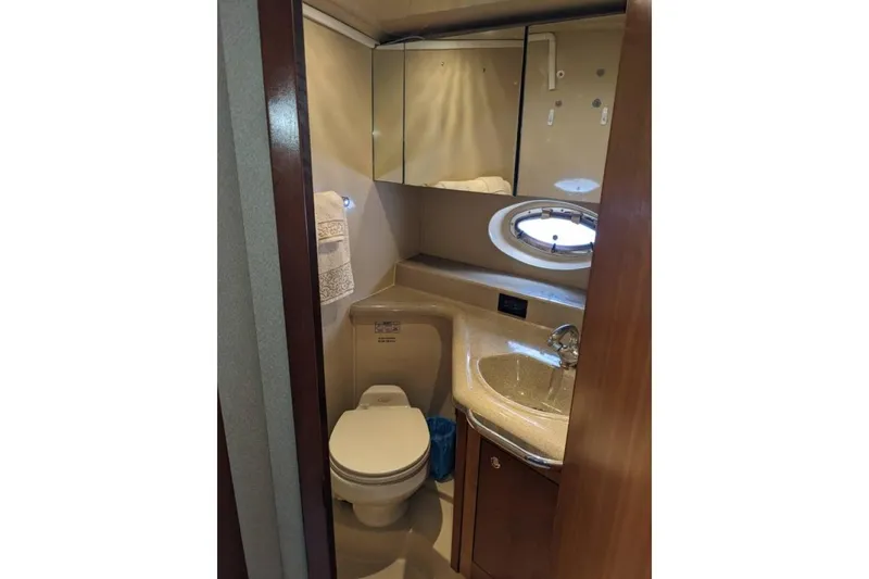 Slide: The Image of Compact bathroom in 2003 Cruisers 3970 yacht with sink, toilet, and mirrored cabinet. - 12