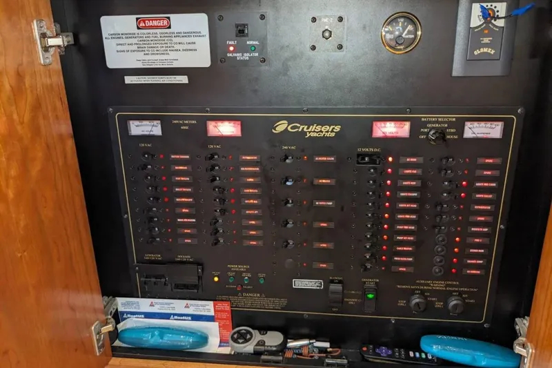 Slide: The Image of Electrical control panel of a 2003 Cruisers 3970 yacht with various switches and meters. - 13