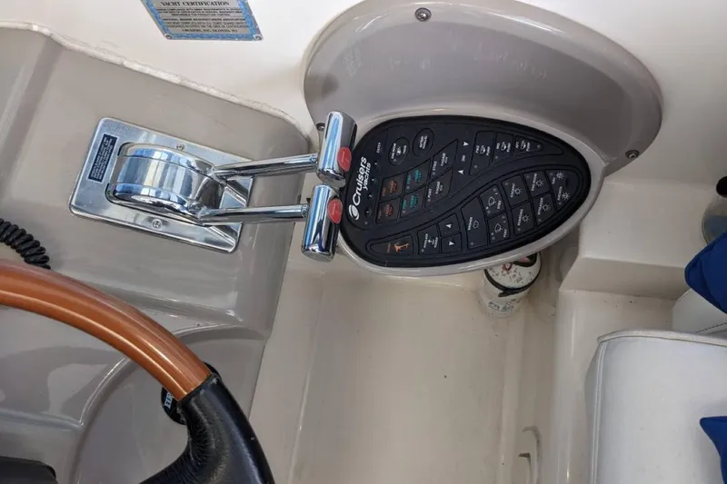 Slide: The Image of Control panel and throttle of a 2003 Cruisers 3970 yacht. - 14