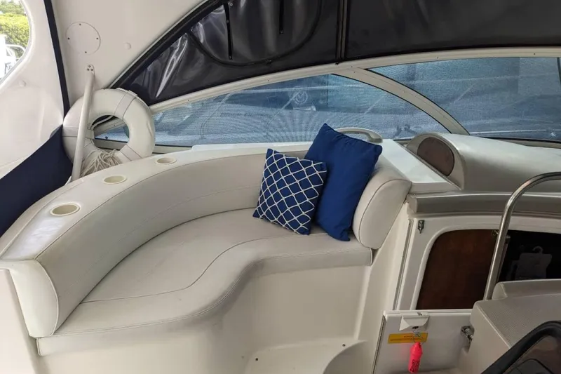 Slide: The Image of Interior of 2003 Cruisers 3970 yacht with white seating and blue cushions. - 15