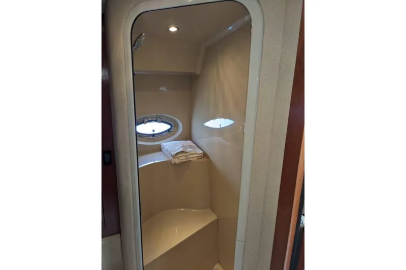Slide: The Image of 2003 Cruisers 3970 yacht shower with porthole and towel. - 16
