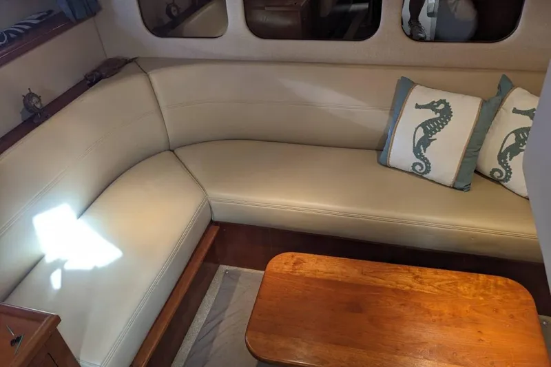 Slide: The Image of 2003 Cruisers 3970 yacht interior with beige seating and seahorse-themed pillows. - 18