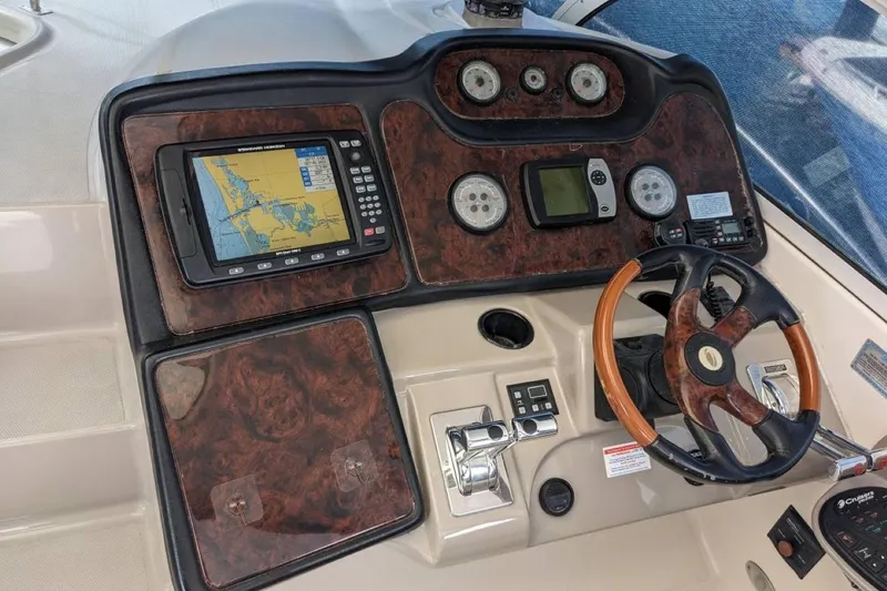 Slide: The Image of Cockpit of 2003 Cruisers 3970 yacht with navigation system and wooden steering wheel. - 4
