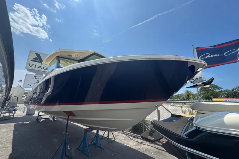 The Image of 2026 Chris-Craft Calypso 32 boat displayed outdoors under a clear blue sky. - 1
