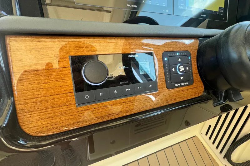 Slide: The Image of 2026 Chris-Craft Calypso 32 dashboard featuring Fusion audio system and Seakeeper controls. - 12