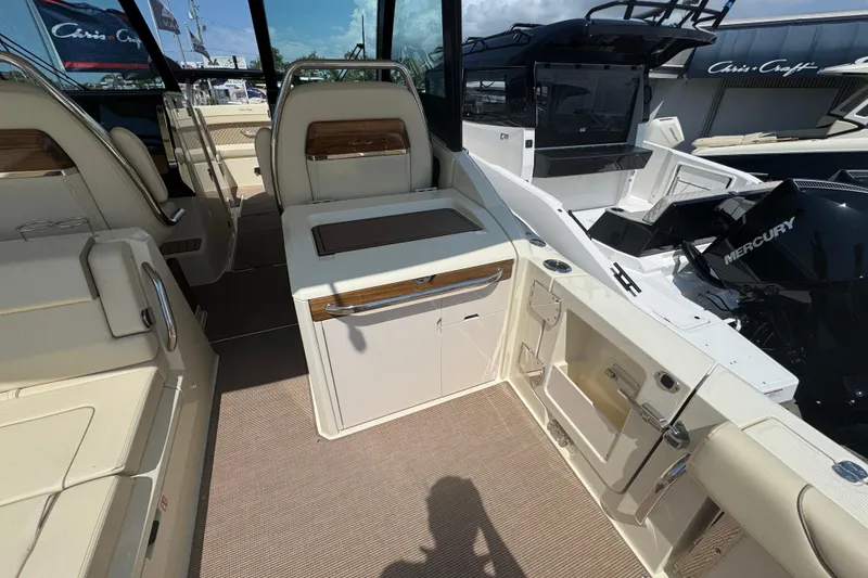 Slide: The Image of 2026 Chris-Craft Calypso 32 boat interior with seating and Mercury engine. - 17