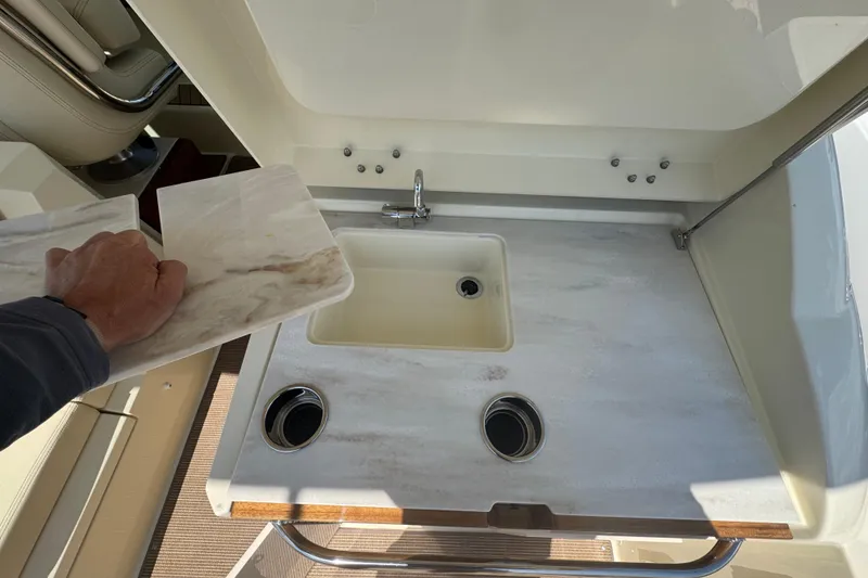 Slide: The Image of 2026 Chris-Craft Calypso 32 boat sink area with marble countertop and faucet. - 20