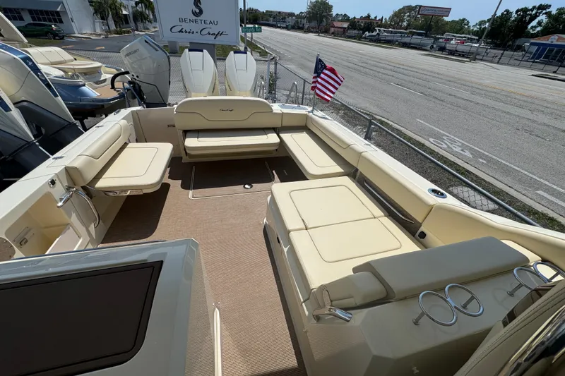 Slide: The Image of 2026 Chris-Craft Calypso 32 boat interior with beige seating and American flag. - 21