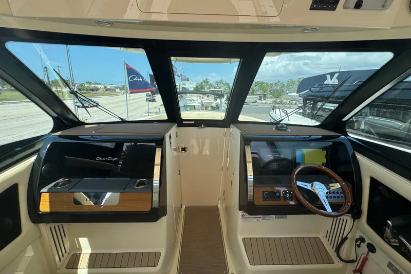 Slide: The Image of 2026 Chris-Craft Calypso 32 helm with modern controls and panoramic windows. - 32