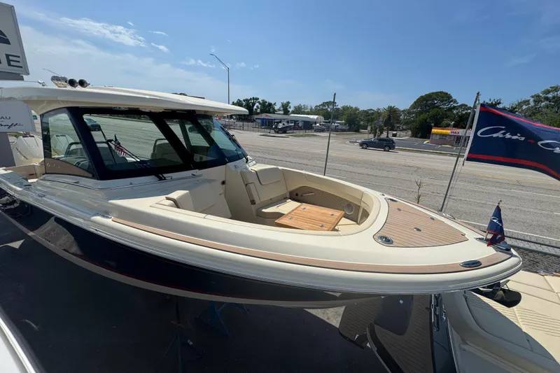 Slide: The Image of 2026 Chris-Craft Calypso 32 boat with elegant design, docked under clear skies. - 34