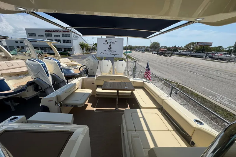 Slide: The Image of 2026 Chris-Craft Calypso 32 boat interior with seating and table, displayed at a dealership. - 37