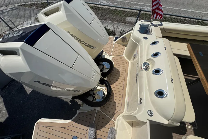 Slide: The Image of 2026 Chris-Craft Calypso 32 boat with dual Mercury engines and American flag. - 42