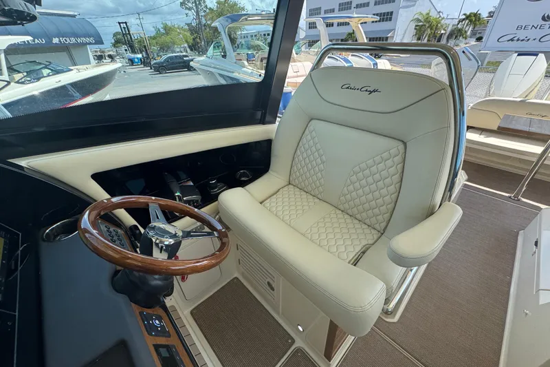 Slide: The Image of Captain's chair and helm of 2026 Chris-Craft Calypso 32 boat, featuring luxurious design. - 49
