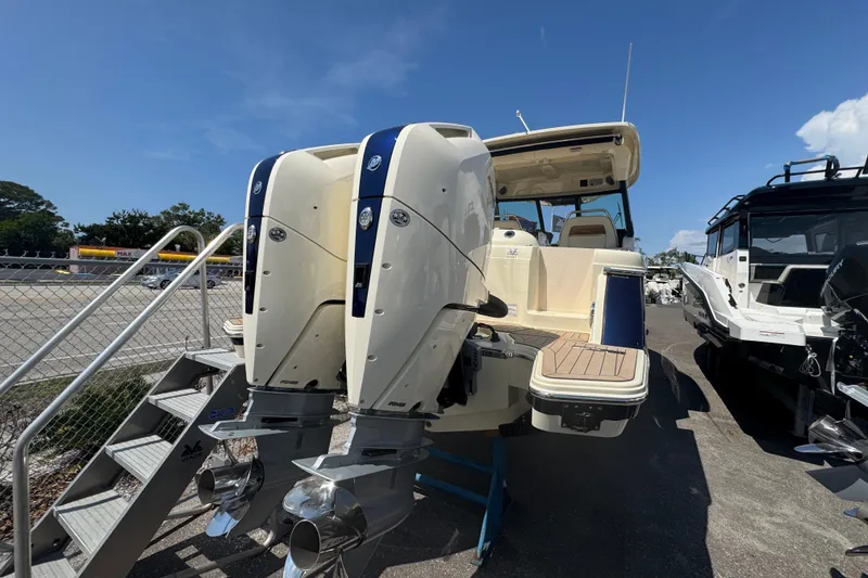 Slide: The Image of 2026 Chris-Craft Calypso 32 boat with dual outboard engines, parked outdoors. - 54