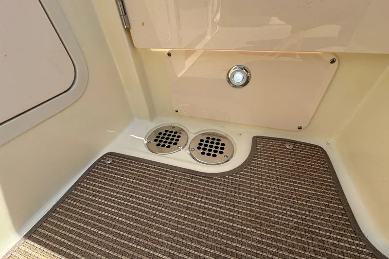 Slide: The Image of Interior detail of 2026 Chris-Craft Calypso 32 boat, featuring drainage and textured flooring. - 55
